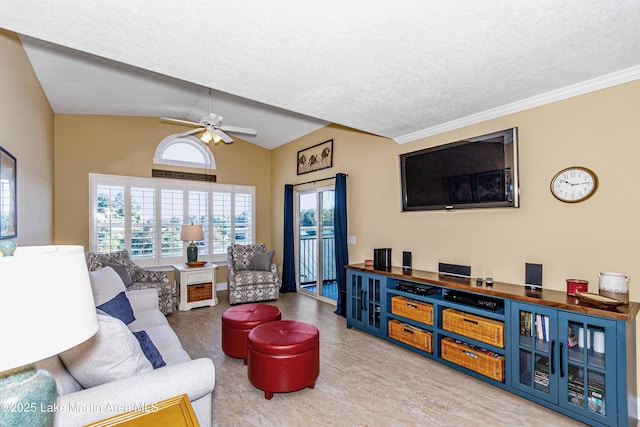 living area with plenty of natural light, a textured ceiling, lofted ceiling, and ceiling fan