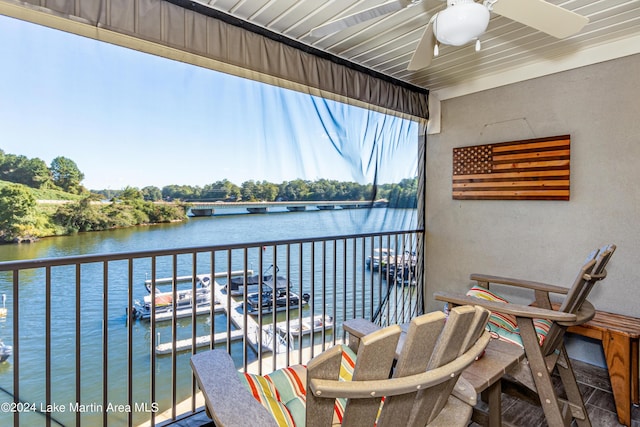 balcony with a water view and ceiling fan