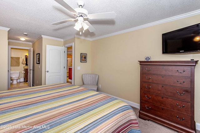 carpeted bedroom featuring a textured ceiling, crown molding, baseboards, and ensuite bathroom