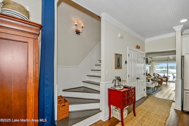 421 Mccain Rd, Eclectic, AL 36024 - stairs featuring crown molding, wood finished floors, and wainscoting