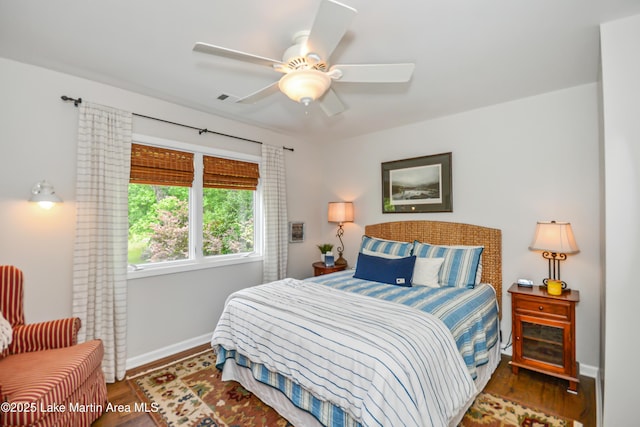 421 Mccain Rd, Eclectic, AL 36024 - bedroom with baseboards, wood finished floors, and a ceiling fan