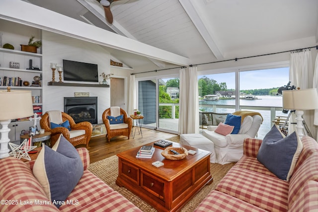 421 Mccain Rd, Eclectic, AL 36024 - living area with wood finished floors, a glass covered fireplace, and ceiling fan