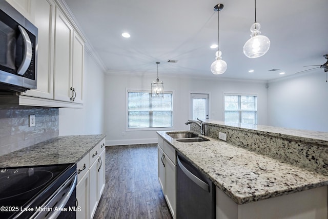 kitchen with white cabinetry, sink, stainless steel appliances, and light stone countertops