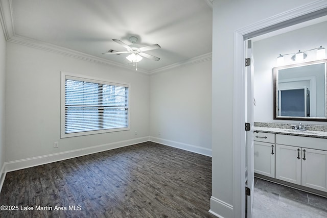 unfurnished room with ornamental molding, dark hardwood / wood-style floors, sink, and ceiling fan