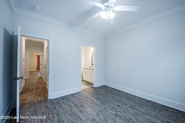 unfurnished bedroom featuring connected bathroom, crown molding, and dark hardwood / wood-style floors