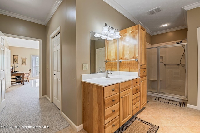 bathroom with tile patterned flooring, vanity, crown molding, and a shower with shower door