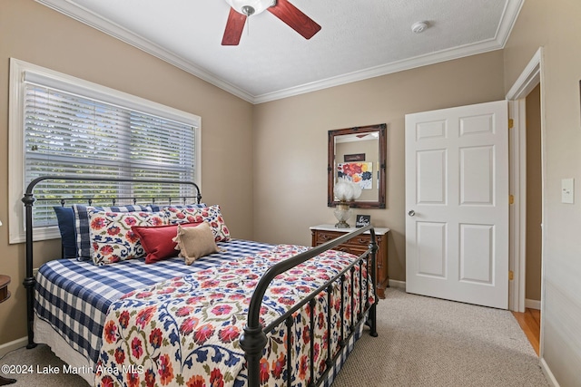 carpeted bedroom featuring ceiling fan, a textured ceiling, and ornamental molding