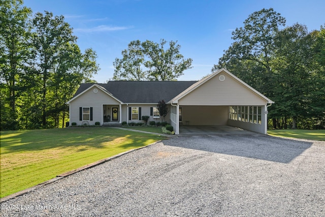 ranch-style house featuring a front yard and a carport