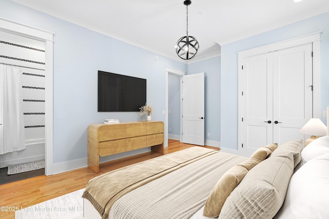 1412 Annalue Dr, Auburn, AL 36830 - bedroom with baseboards, wood finished floors, a closet, and ornamental molding
