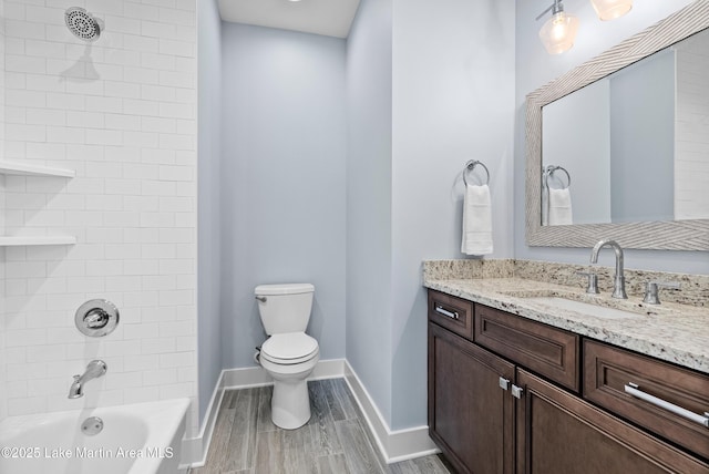 1412 Annalue Dr, Auburn, AL 36830 - bathroom with toilet, vanity, washtub / shower combination, baseboards, and wood finished floors
