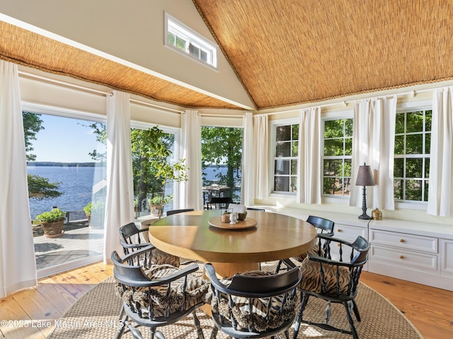 sunroom featuring a water view