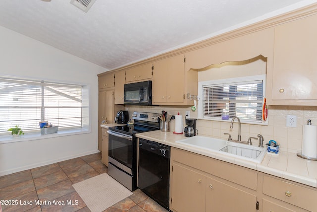 100 Royal Dr, Equality, AL 36026 - kitchen with vaulted ceiling, a healthy amount of sunlight, black appliances, and a sink