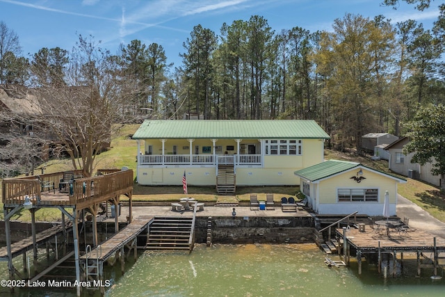 100 Royal Dr, Equality, AL 36026 - rear view of house with a patio area, stairway, metal roof, and a deck with water view