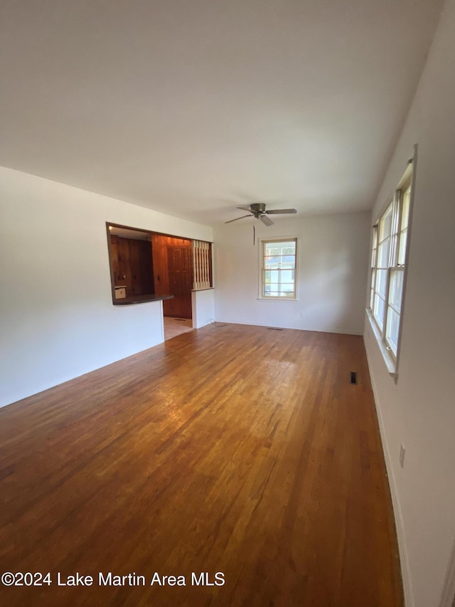 empty room with ceiling fan and wood-type flooring