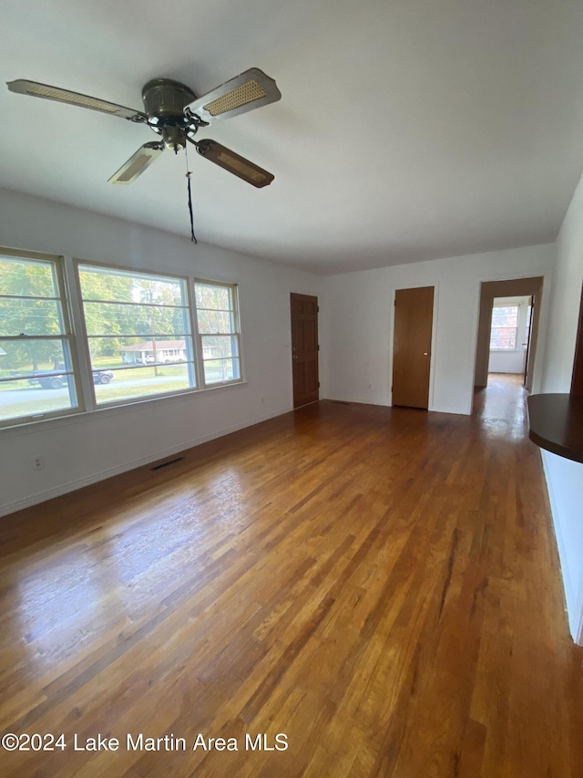 empty room featuring ceiling fan and hardwood / wood-style floors