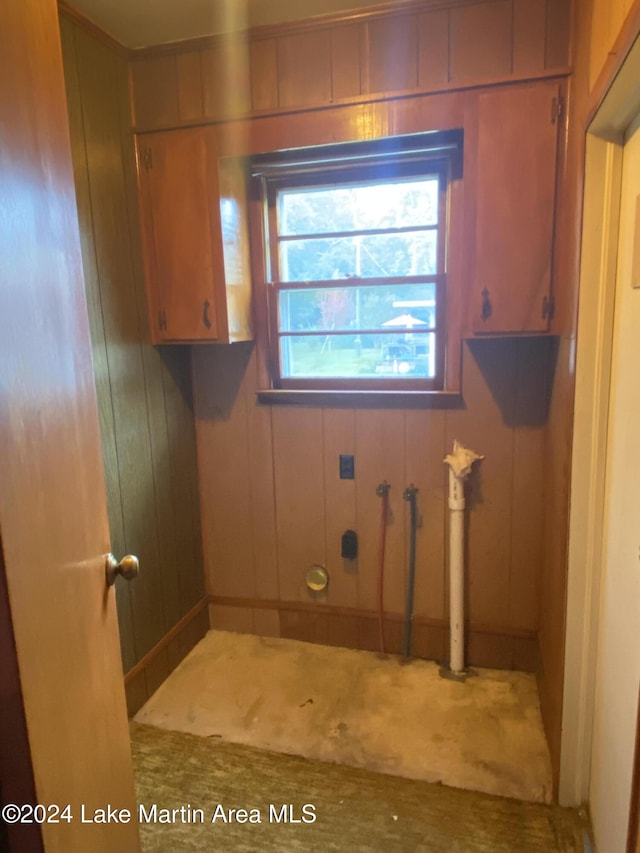 washroom featuring wooden walls