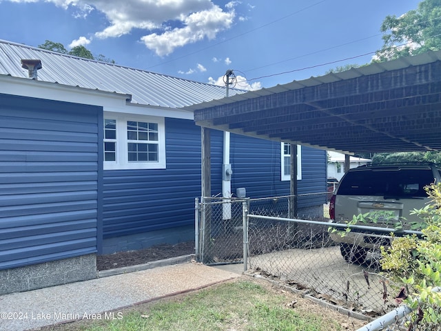 view of side of home featuring a carport