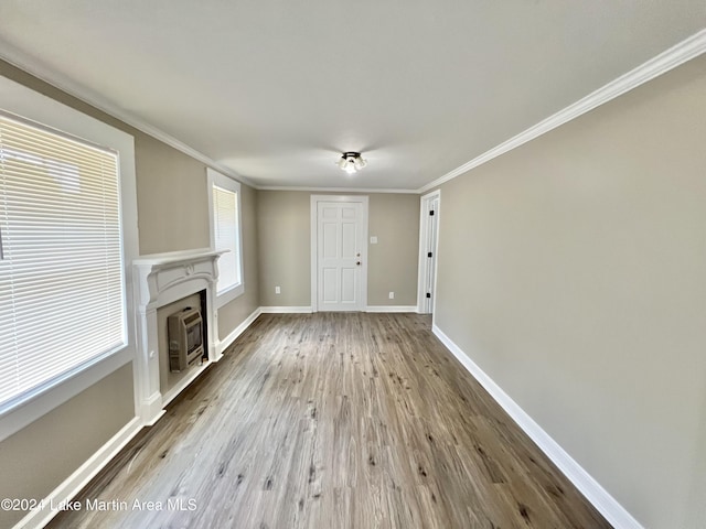 unfurnished living room with light hardwood / wood-style floors and ornamental molding