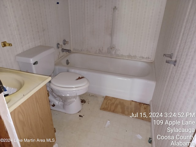 bathroom featuring vanity, toilet, and a bathing tub