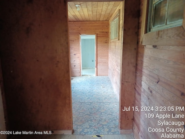 corridor with wood ceiling and wooden walls