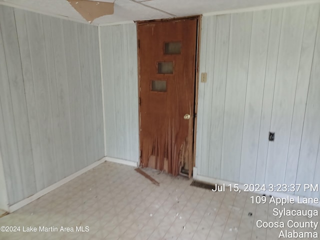 spare room featuring wooden walls