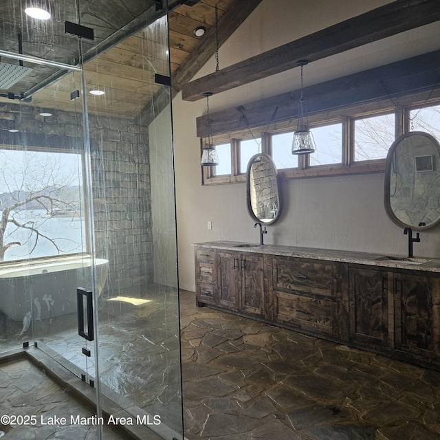 full bathroom with double vanity, marble finish floor, a shower stall, and a sink