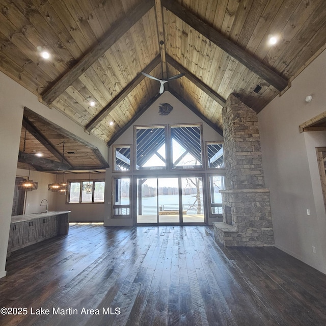 unfurnished living room with wood ceiling, high vaulted ceiling, dark wood-style flooring, and beamed ceiling