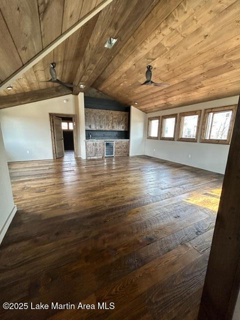 unfurnished living room featuring a ceiling fan, wooden ceiling, vaulted ceiling, and wood-type flooring