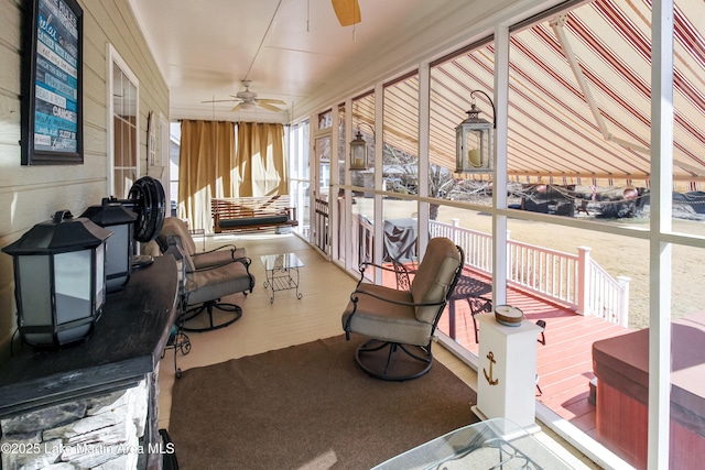 sunroom featuring ceiling fan