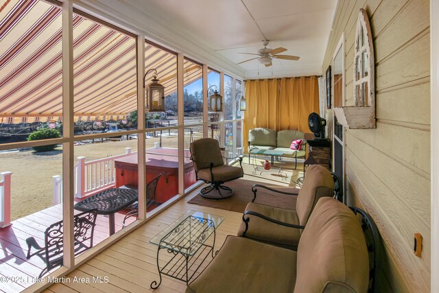 sunroom / solarium featuring ceiling fan