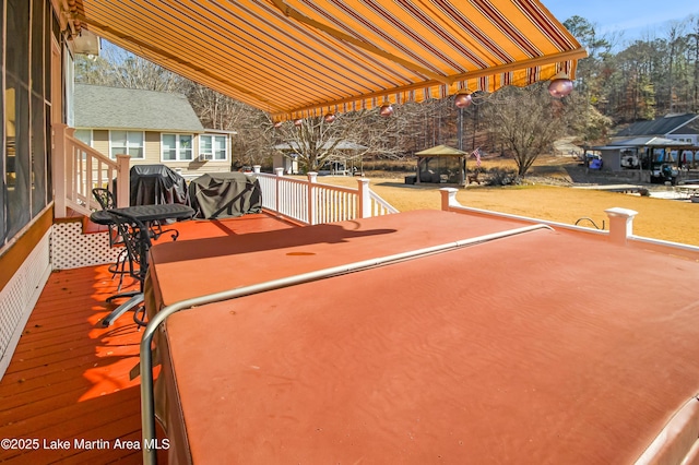 view of patio / terrace featuring grilling area, a wooden deck, and a gazebo