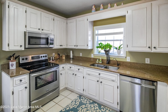 kitchen featuring sink, white cabinets, and appliances with stainless steel finishes