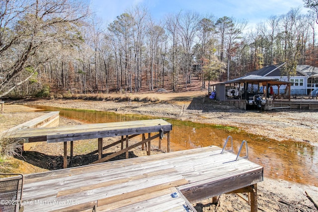 view of dock featuring a gazebo and a water view