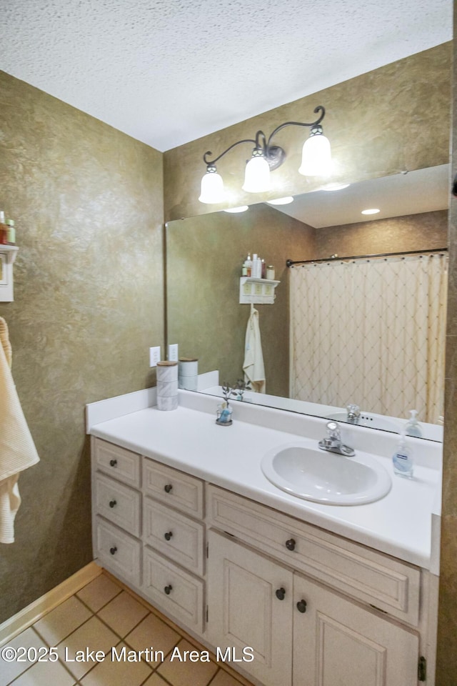 bathroom featuring a textured ceiling, tile patterned floors, vanity, and curtained shower