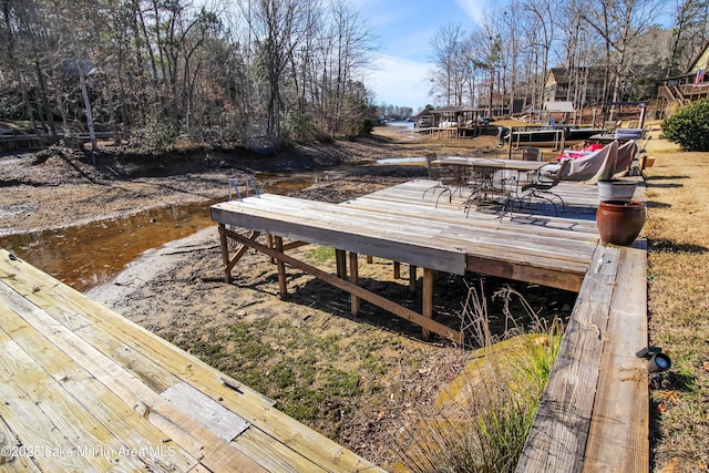 wooden terrace featuring a water view