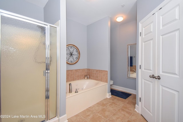 bathroom with tile patterned floors, plus walk in shower, and toilet