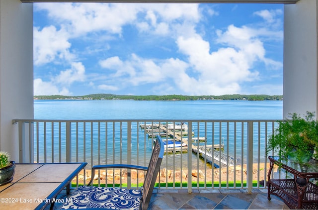 balcony with a boat dock and a water view