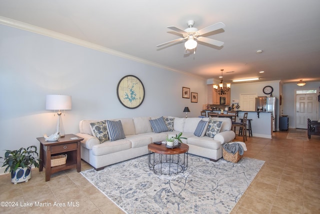 living room with crown molding, light tile patterned floors, and ceiling fan with notable chandelier