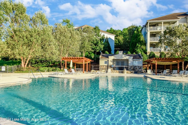 view of pool with a pergola and a patio