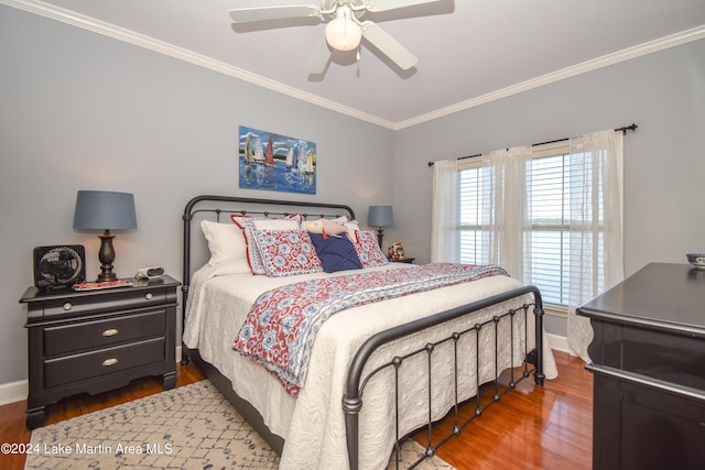 bedroom with ceiling fan, crown molding, and dark wood-type flooring