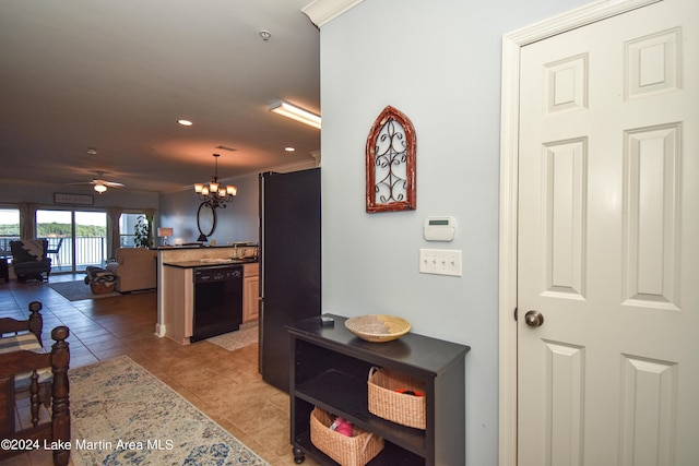 hallway with a notable chandelier, light tile patterned flooring, and crown molding