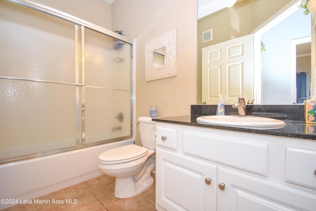 full bathroom with tile patterned flooring, vanity, toilet, and combined bath / shower with glass door