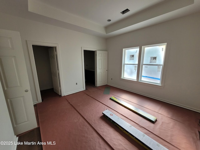 214 Mccain Rd, Eclectic, AL 36024 - unfurnished bedroom featuring carpet and a raised ceiling