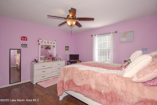 bedroom with dark wood-style flooring and ceiling fan