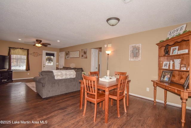 dining space with baseboards, a textured ceiling, and wood finished floors