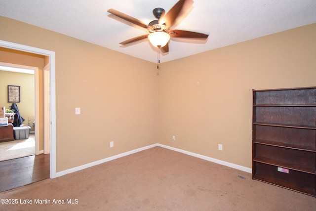 unfurnished bedroom with a ceiling fan, carpet, and baseboards