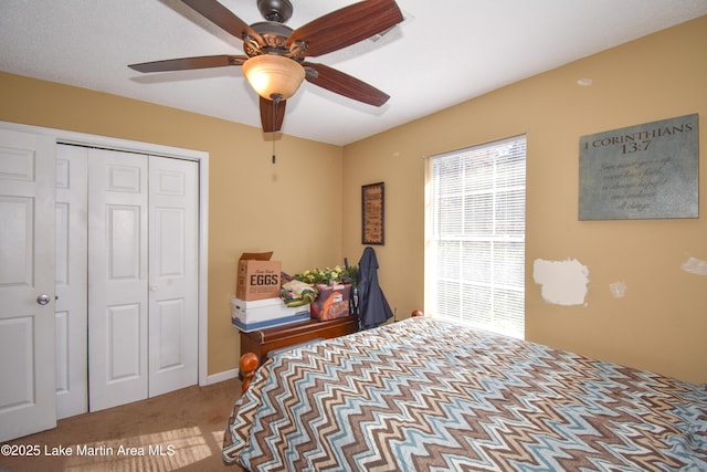 bedroom with carpet flooring, a closet, and ceiling fan