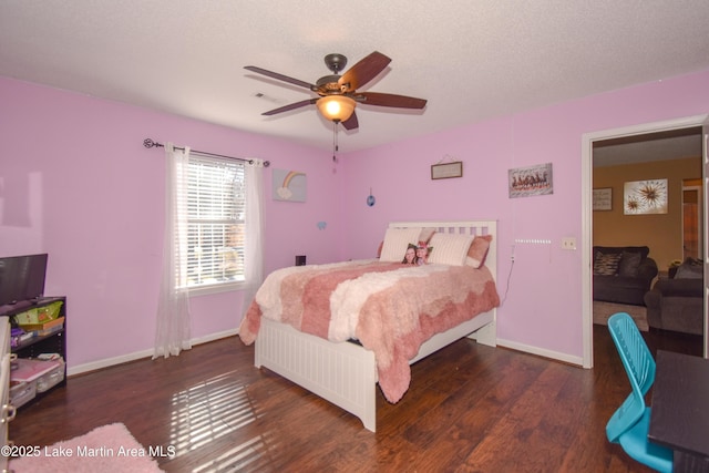 bedroom with visible vents, ceiling fan, baseboards, and wood finished floors