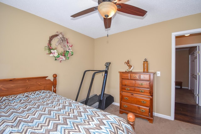 carpeted bedroom with ceiling fan and baseboards