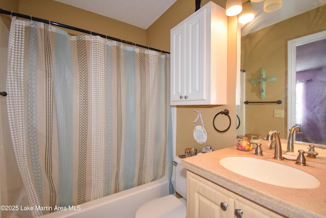 bathroom with shower / bathtub combination with curtain, toilet, and vanity